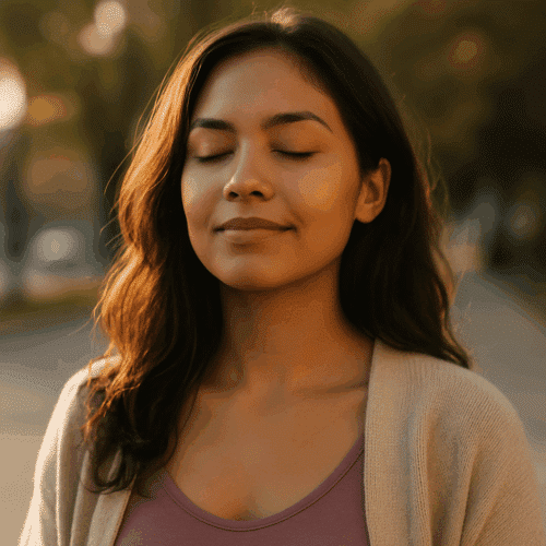 A peaceful young woman with closed eyes standing in golden sunlight, symbolizing inner healing and self-love.