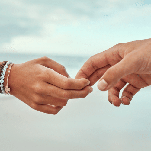Minimalist black and white hand illustration representing release, healing, and clearing old energy.